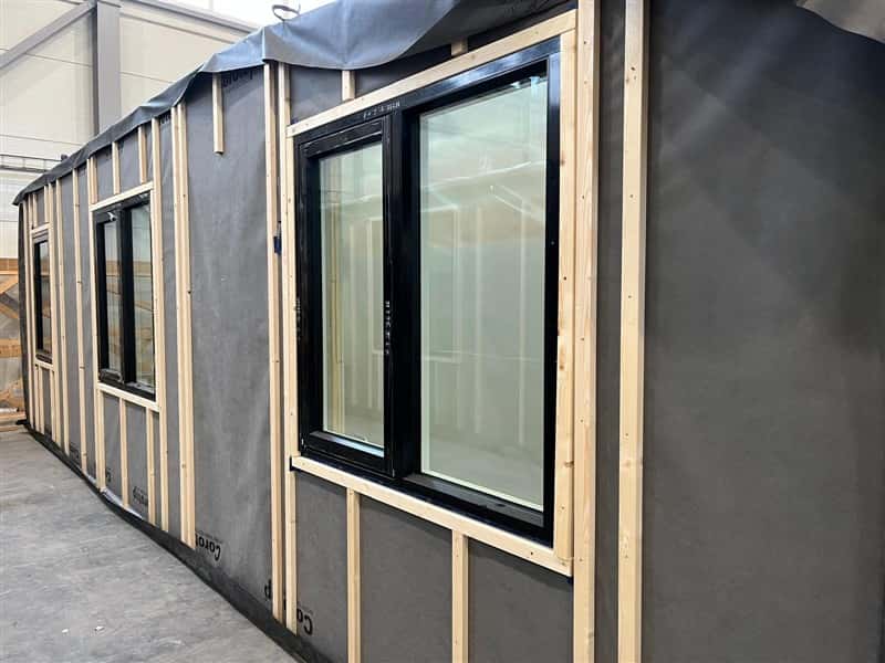Timber frame panel with factory-fitted windows